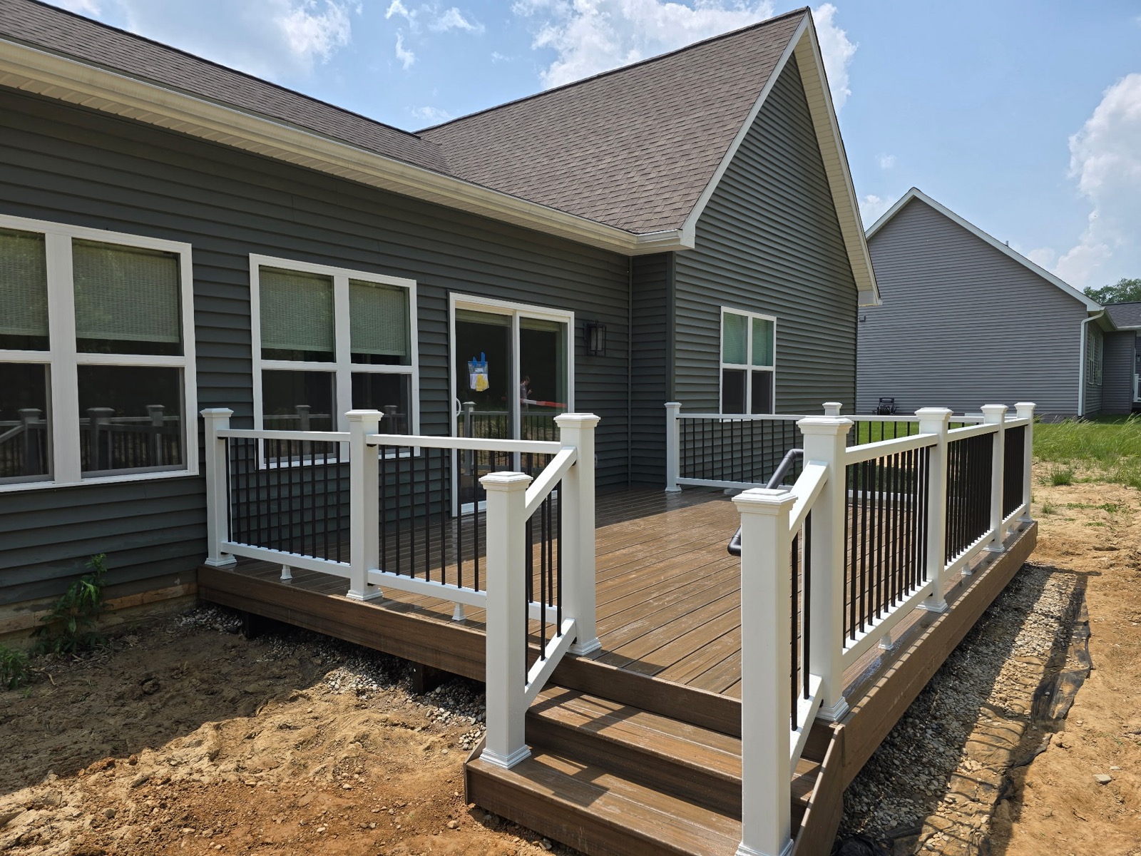 New construction composite deck with white and black railings
